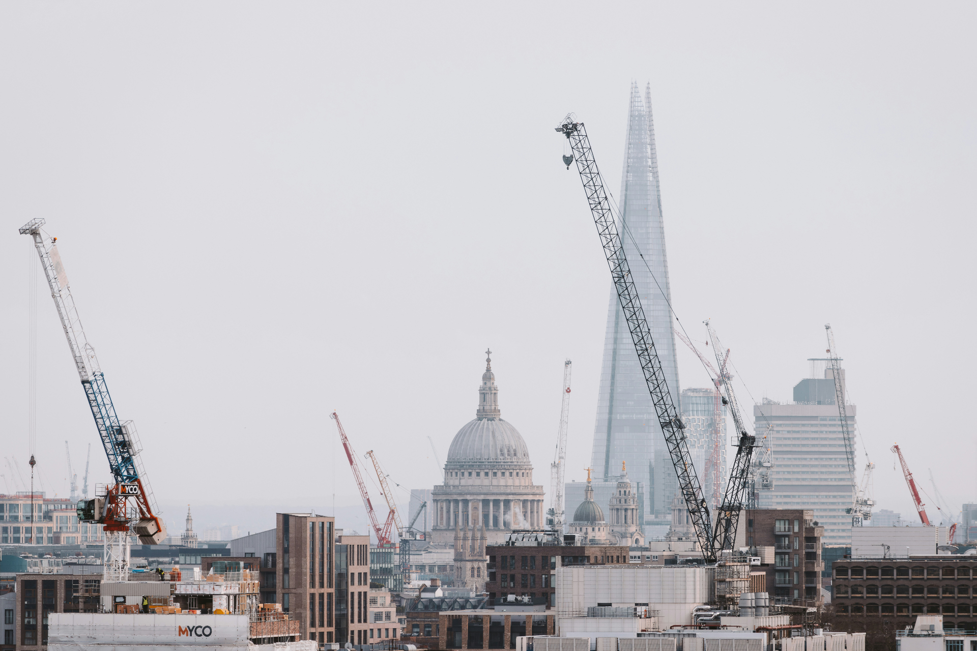 London skyline with construction cranes near St Paul's and The Shard